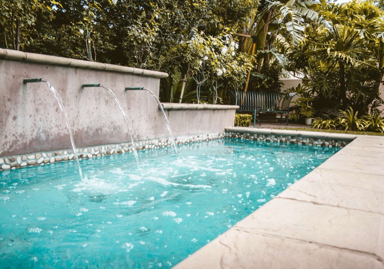 The pool and fountain in the garden at Natural Expressions Aesthetics